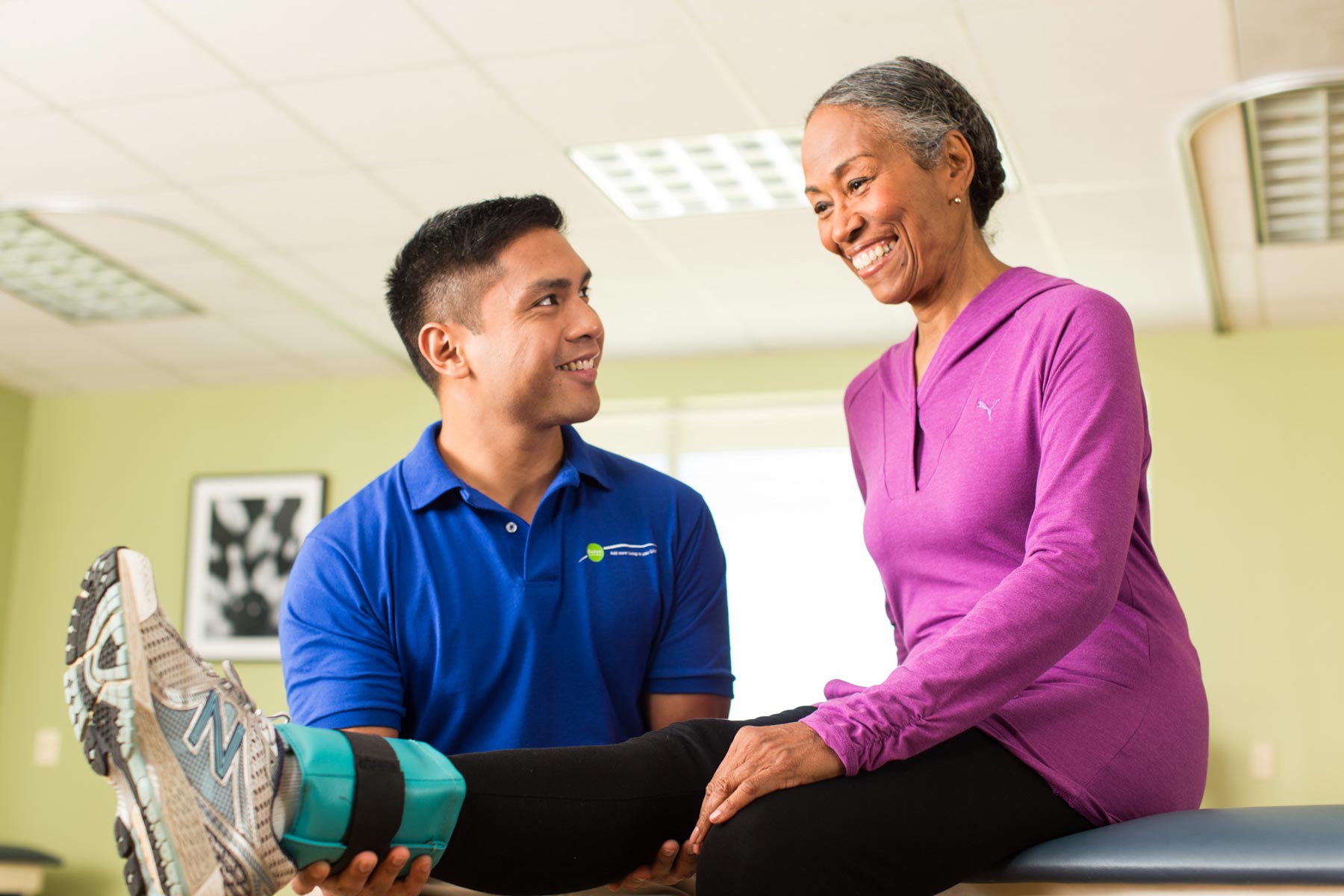 Therapist assisting patient with rehab exercises
